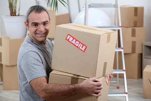 Moving boxes and protected furniture during a Holland Park removal