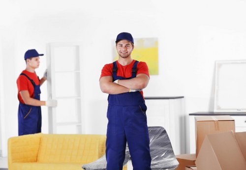 Local movers loading furniture during a Holland Park relocation