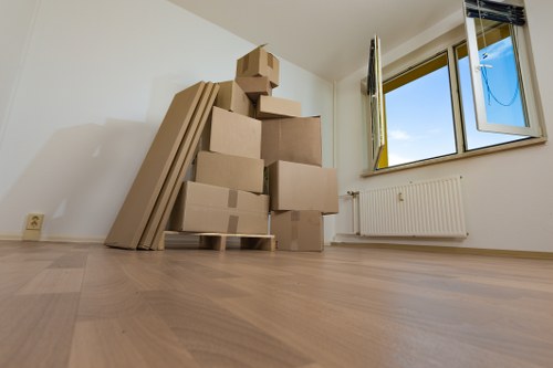 Moving team handling furniture in a Hollandpark flat