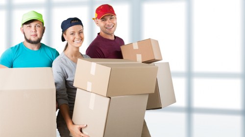 Packed boxes and furniture loaded for a Holland Park moving truck service