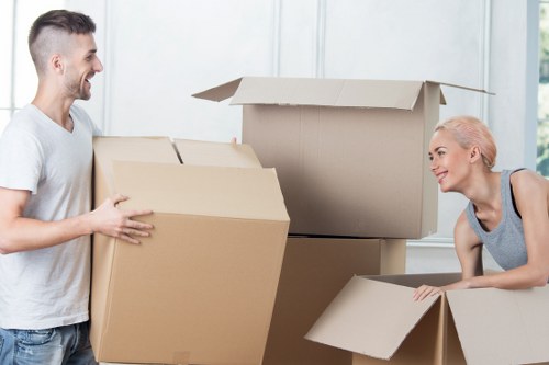 Household movers handling furniture in Hollandpark