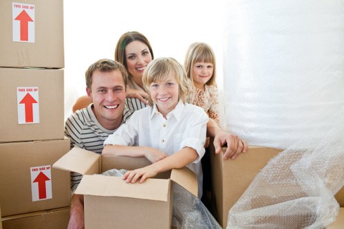 Professional movers carrying furniture from a period property in Holland Park