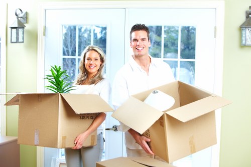 Removal workers loading furniture during a Hollandpark relocation