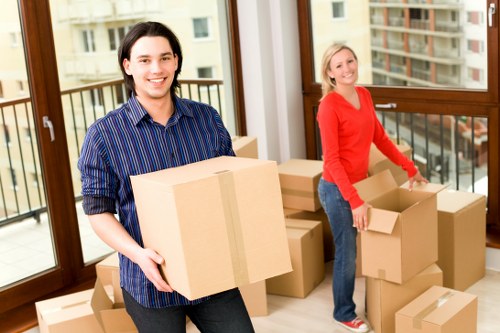 Professional movers loading furniture into a moving truck in Hollandpark